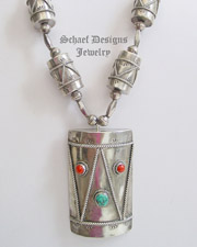 Johnson Todacheeny artist signed turquoise, coral, sterling silver Native American collectible drum necklace || online upscale native American jewelry boutique gallery| Schaef Designs Southwestern turquoise Jewelry | Arizona 